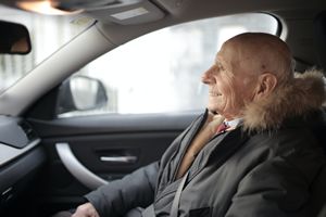 Elderly Man Riding in Car