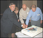 Photo: FHWA Administrator Rick Capka assists in the ceremonial cake-cutting for the 50th anniversary of the Interstate Highway System, joined by (L-R): Cindy Burbank, Associate Administrator, Office of Planning, Environment and Realty, FHWA; Bob Mahoney, FHWA LA Division; and Bill O'Donnell, FHWA NH Division.
