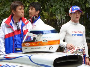 Anthony Davidson with Derek Bell's helmet in the foreground at 2014 Goodwood Festival of Speed