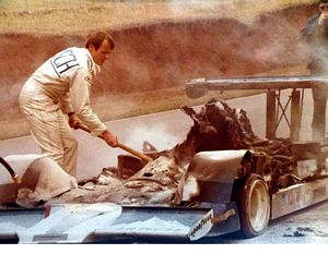 Al Holbert put out fire in Busch Can-Am car