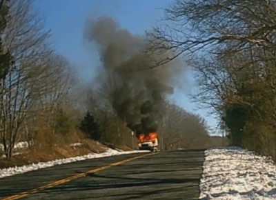 image of u-haul getaway van burning on roadside 