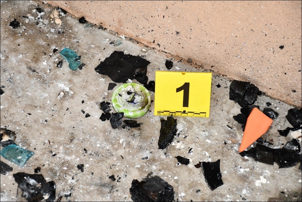 A picture containing fire debris and yellow evidence tent 1.