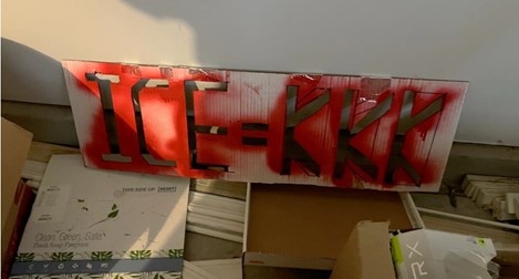  Red and white stencil that reads ICE = KKK.