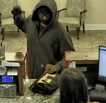 Man with mask and in gray hoodie